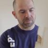man looking at timber